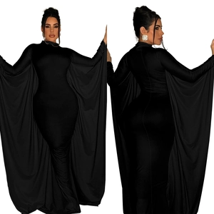 Detail of solid black long sleeve maxi dress with dramatic floor-length wing cape sleeves