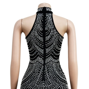 Detail of black halter dress with radiating silver rhinestone pattern and back zipper