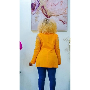 Rear view of orange slim fit blazer with white pearls on shoulders and sleeves