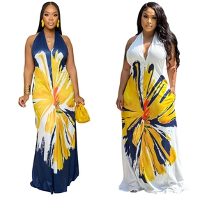Detail of backless halter maxi dress with vibrant sunflower floral print and V-neckline