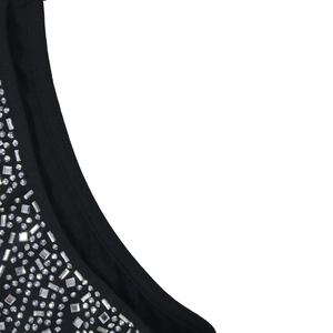 Close-up of sparkling silver rhinestones on the neckline of a black sleeveless dress