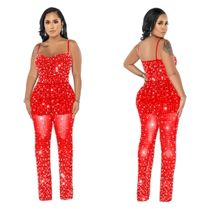Detailed view of red sparkling rhinestones and sheer mesh panels on party jumpsuit
