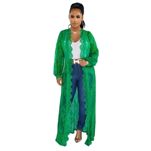 Detailed view of the emerald green lace cardigan featuring delicate floral hollow patterns