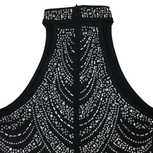 Macro detail of halter neck dress featuring intricate silver rhinestones and sequins