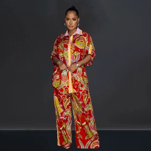 Detail of red paisley print short sleeve shirt and wide-leg pants set with striped collars