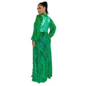 Detailed close-up of green lace dress texture featuring intricate floral pattern embroidery