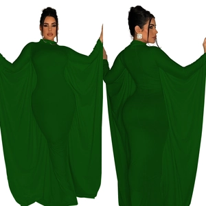 Detail of elegant dark green floor-length dress with dramatic cape split sleeves