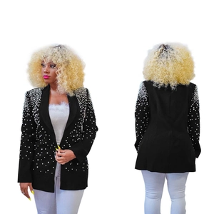 Detail of elegant black blazer featuring hand-sewn pearl embellishments on shoulders and lapel