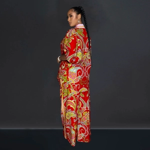 Detail of red paisley satin two-piece set featuring wide-leg pants and loose long sleeve top