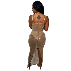 Detail view of champagne mesh evening gown featuring sparkling rhinestones and a back slit