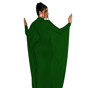 Detail of dark green evening dress featuring dramatic cape sleeves and slim fit silhouette