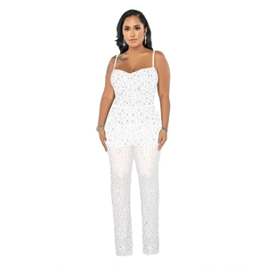 Detailed close-up of white sequin rhinestone jumpsuit with mesh and spaghetti straps