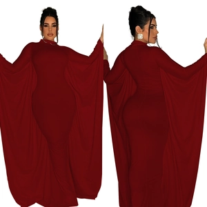 Close-up of wine red slim fit maxi dress featuring dramatic oversized cape sleeves