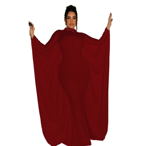 Detail of elegant dark red maxi dress featuring dramatic batwing cape sleeves and slim fit