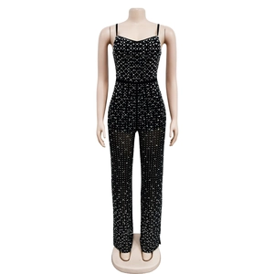 Detailed view of black rhinestone mesh jumpsuit with geometric sequin patterns