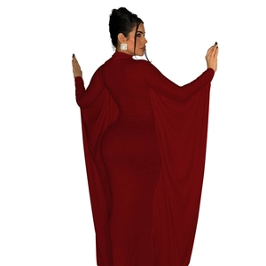 Detail of dark red bodycon maxi dress with flowing cape sleeves and glossy knit fabric