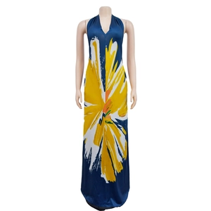 Detail view of deep blue halter maxi dress with large yellow abstract flower pattern