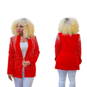 Detail of red blazer with white pearl embellishments on the lapel and sleeves