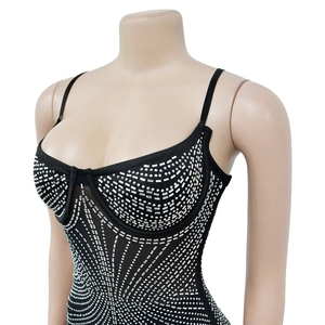 Macro shot of silver rhinestone geometric patterns on black mesh bodysuit fabric