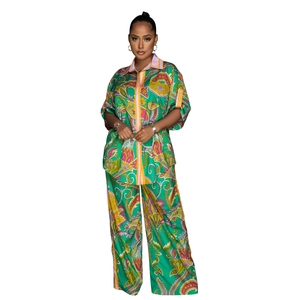 Detailed view of the vibrant green paisley floral print on woven shirt and trousers