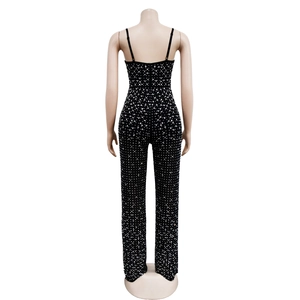 Detail of black rhinestone jumpsuit with thin straps and low-back design on mannequin