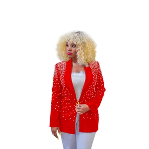 Detailed close-up of a red blazer featuring exquisite white pearl beading on the lapel