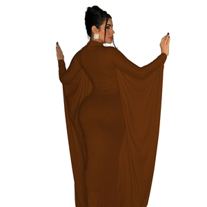 Detail view of brown long sleeve dress featuring elegant cape back and flowing silhouette
