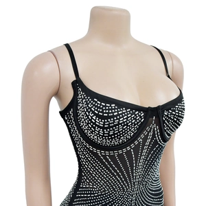 Detail of black slim-fit dress with silver rhinestones in a radial symmetric pattern