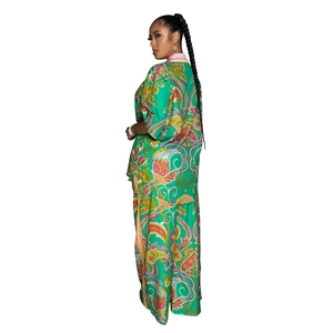 Detail of green paisley print on the lightweight wide-leg trousers and matching cardigan