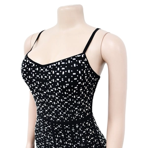 Close-up detail of silver geometric rhinestones on black mesh sleeveless jumpsuit fabric