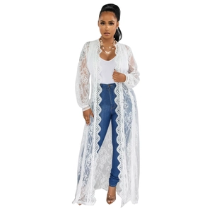 Close-up of white long lace cardigan featuring delicate floral embroidery and scalloped edges