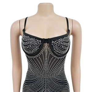 Close-up of black mesh dress featuring intricate silver rhinestones and stud patterns