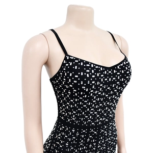 Detail of black rhinestone mesh romper with silver sparkling crystals on plain background