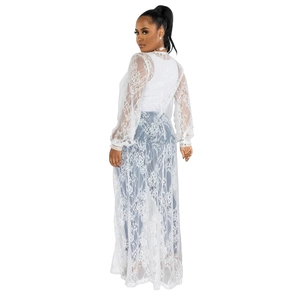 Detailed back view of white lace cardigan showing intricate vintage floral patterns