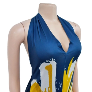 Detailed view of deep blue halter dress with white and yellow abstract brushstroke print