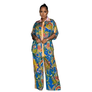 Detail view of the vibrant blue paisley print and fabric texture on two-piece fashion set