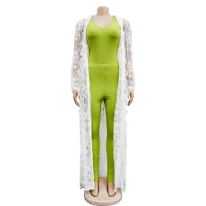 Three-piece women's outfit with green V-neck top, leggings, and long white lace cardigan