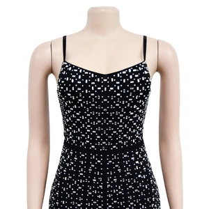Close-up of black mesh jumpsuit featuring intricate silver rhinestone patterns and thin straps