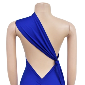 Detail view of backless asymmetric dress with metal ring and waist tie on dark blue fabric