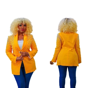 Detail of a bright yellow long sleeve blazer with white pearl embellishments on the shoulders