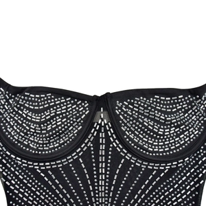 Detail of black corset dress featuring sparkling rhinestones and silver geometric studs