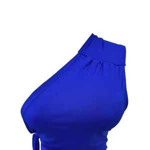 Detailed close-up of blue backless dress fabric showing pleated texture and stitching