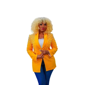 Detail of yellow blazer featuring white pearl embellishments and classic lapel collar