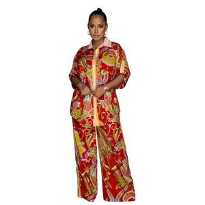 Close-up of red paisley print fabric texture on women's vintage bohemian two-piece set