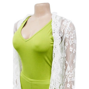Detail of green ribbed V-neck tank top paired with a white floral lace hollow out cardigan