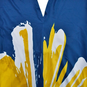 Macro view of V-neckline on dark blue dress with yellow and white abstract floral print