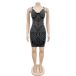 Close-up of black mesh mini dress with intricate silver rhinestone geometric patterns