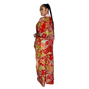 Detail of red paisley print chiffon two-piece set featuring long pants and a kimono cardigan
