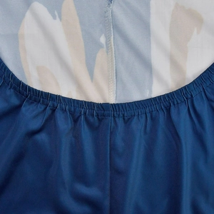 Detailed macro view of the elastic waistband with precise stitching on a printed dress