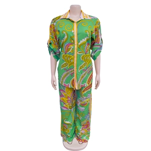 Detail of floral paisley print and button-down front on a green satin two-piece set